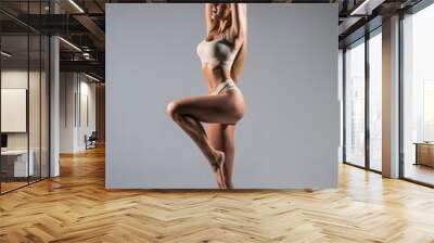 Full height woman with perfect body in underwear isolated over gray background Wall mural